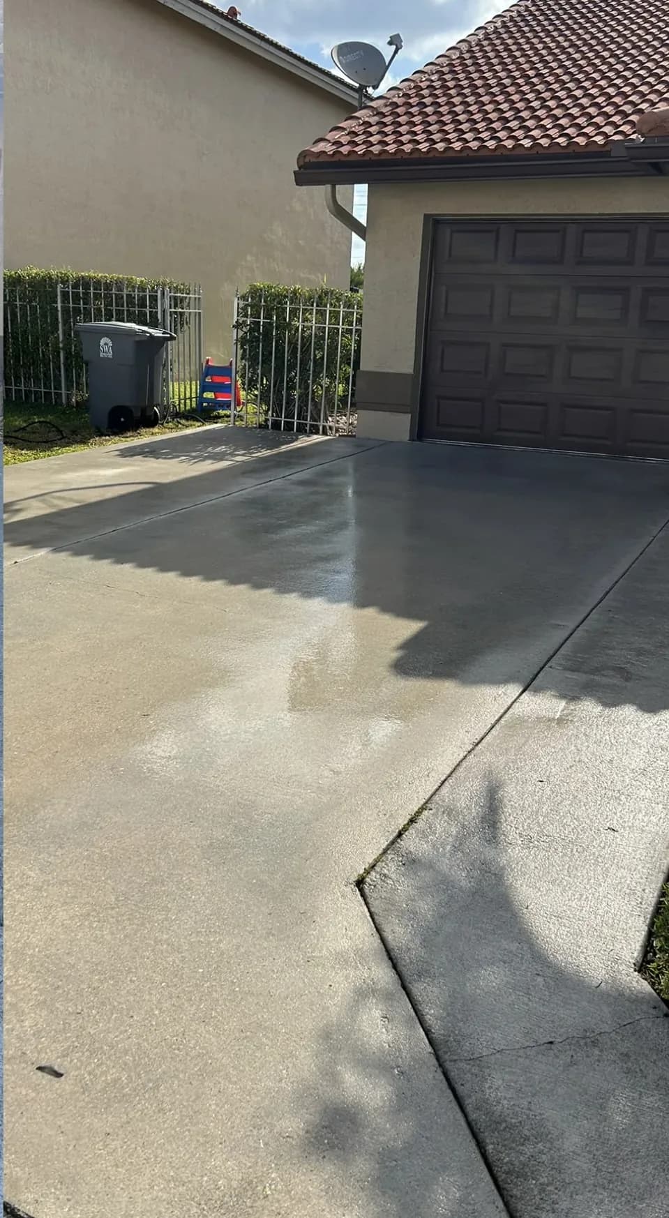 Concrete driveway in front of a garage, after