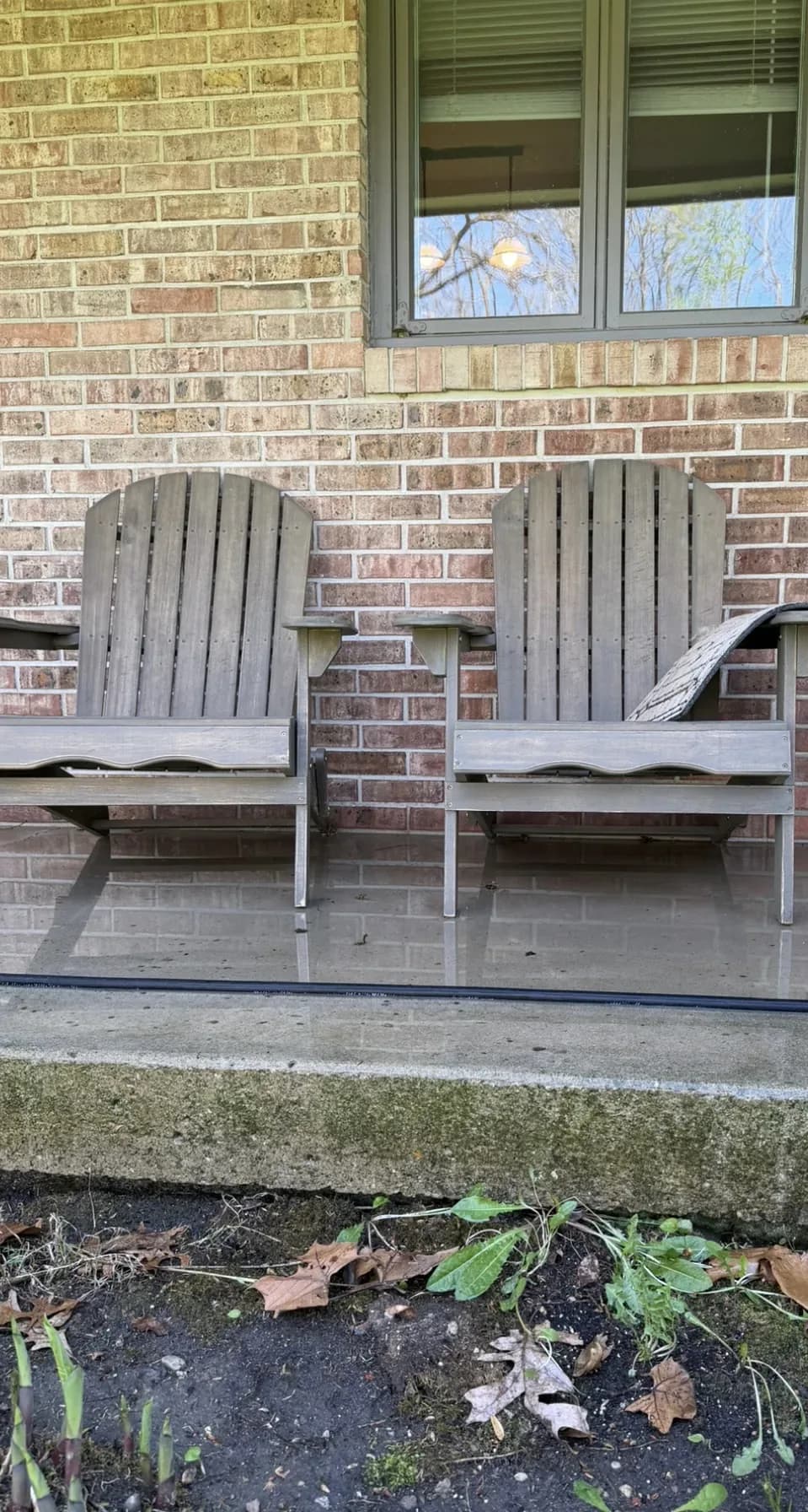 Brick patio with wooden chairs, before