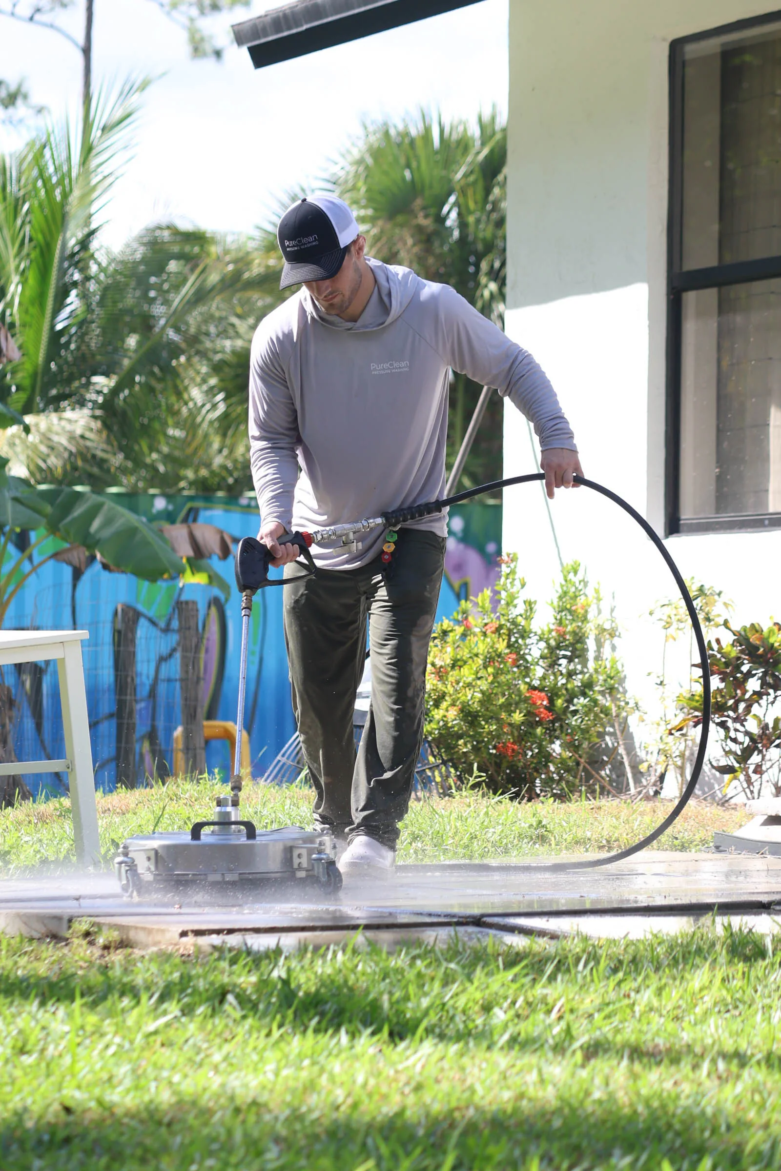 Michael pushing the surface cleaner across a patio
