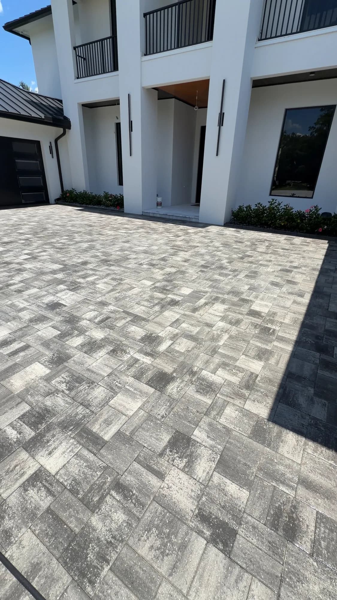 Paver motor court lined with palms at a large estate