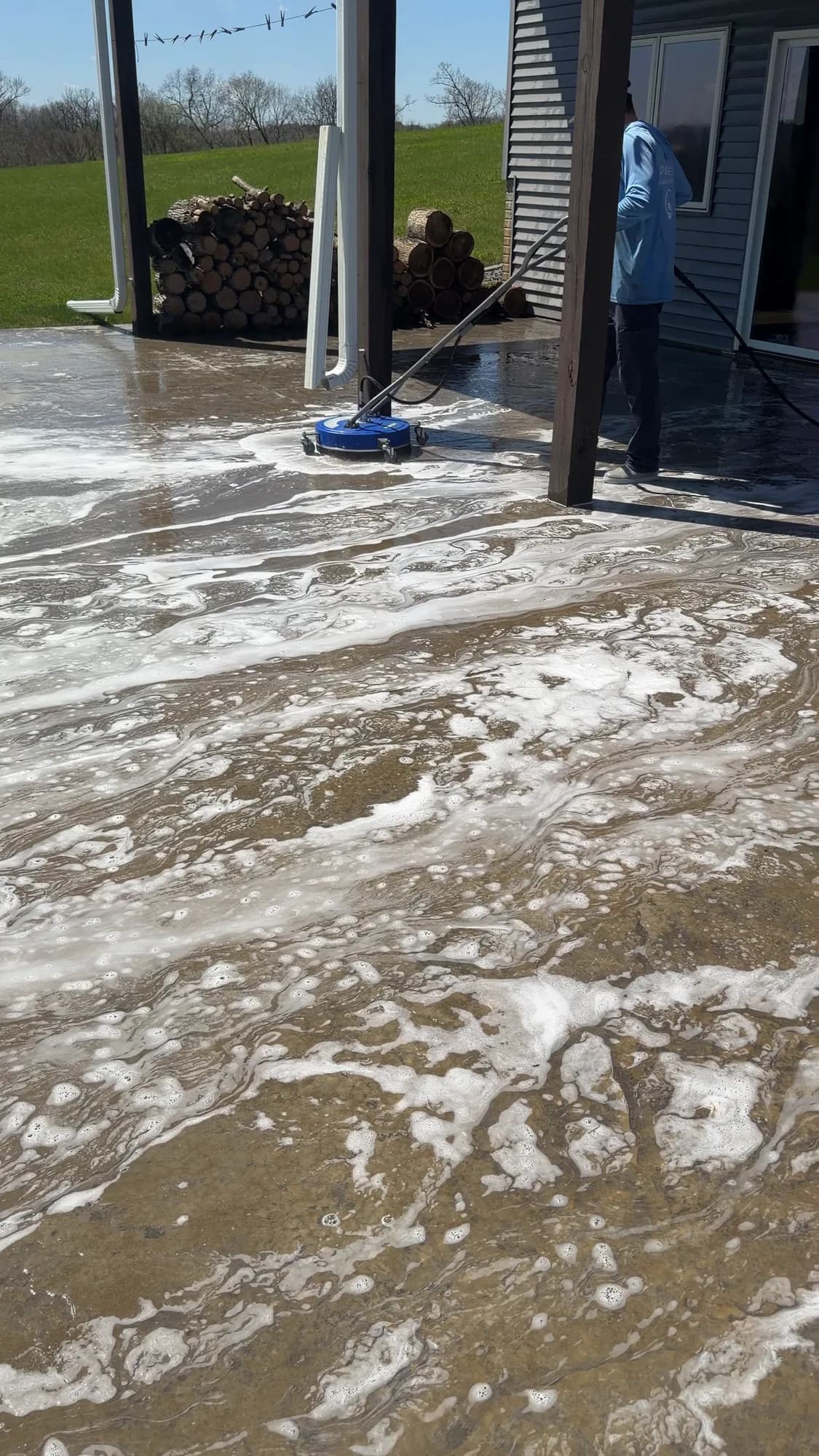 Soft wash detergent foaming on a patio slab