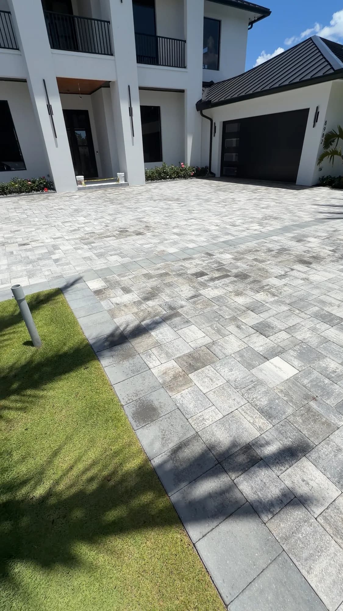 Travertine driveway at a modern white home
