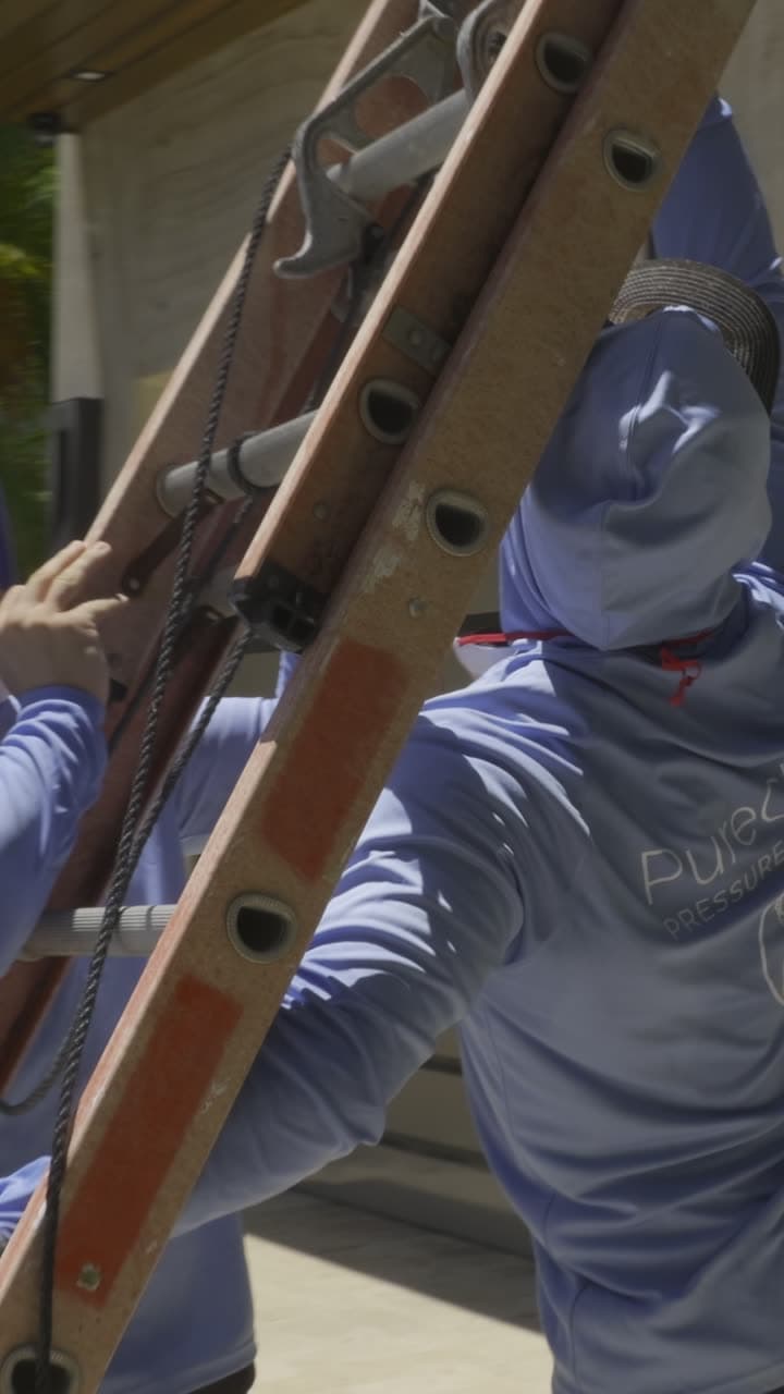 Crew on a ladder in PureClean hoodies