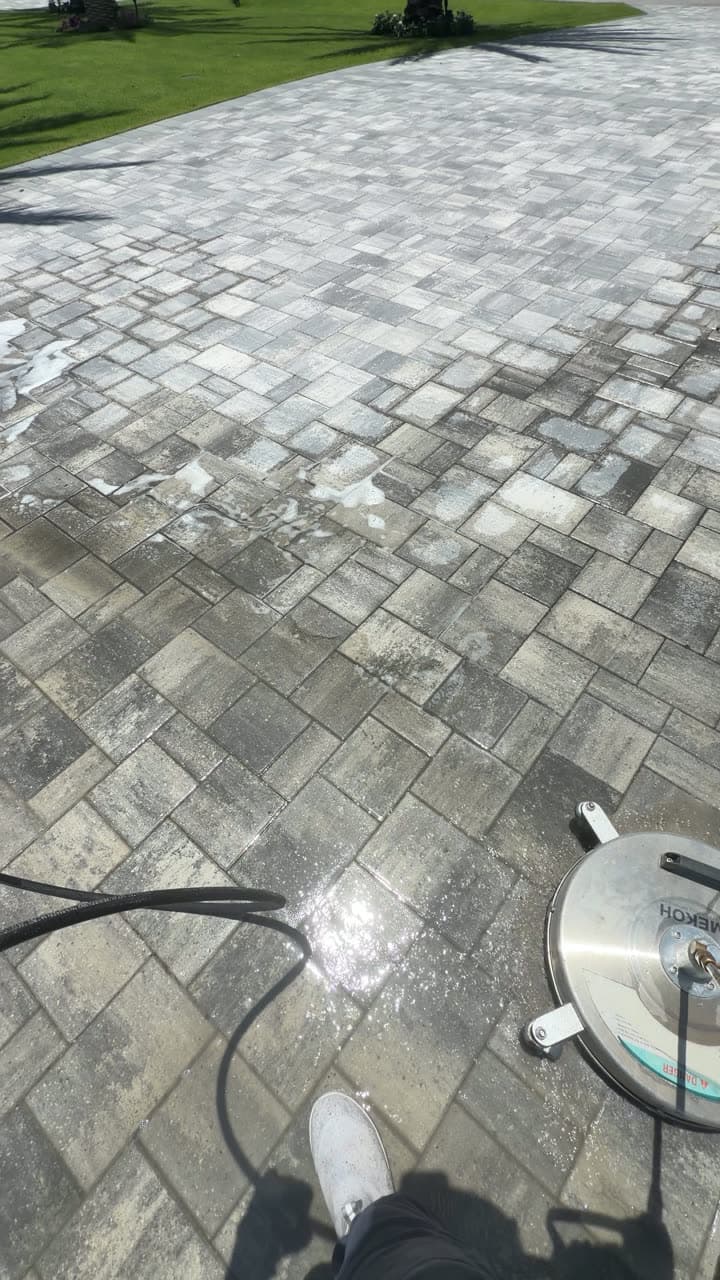 Close on the surface cleaner lifting grime off pavers